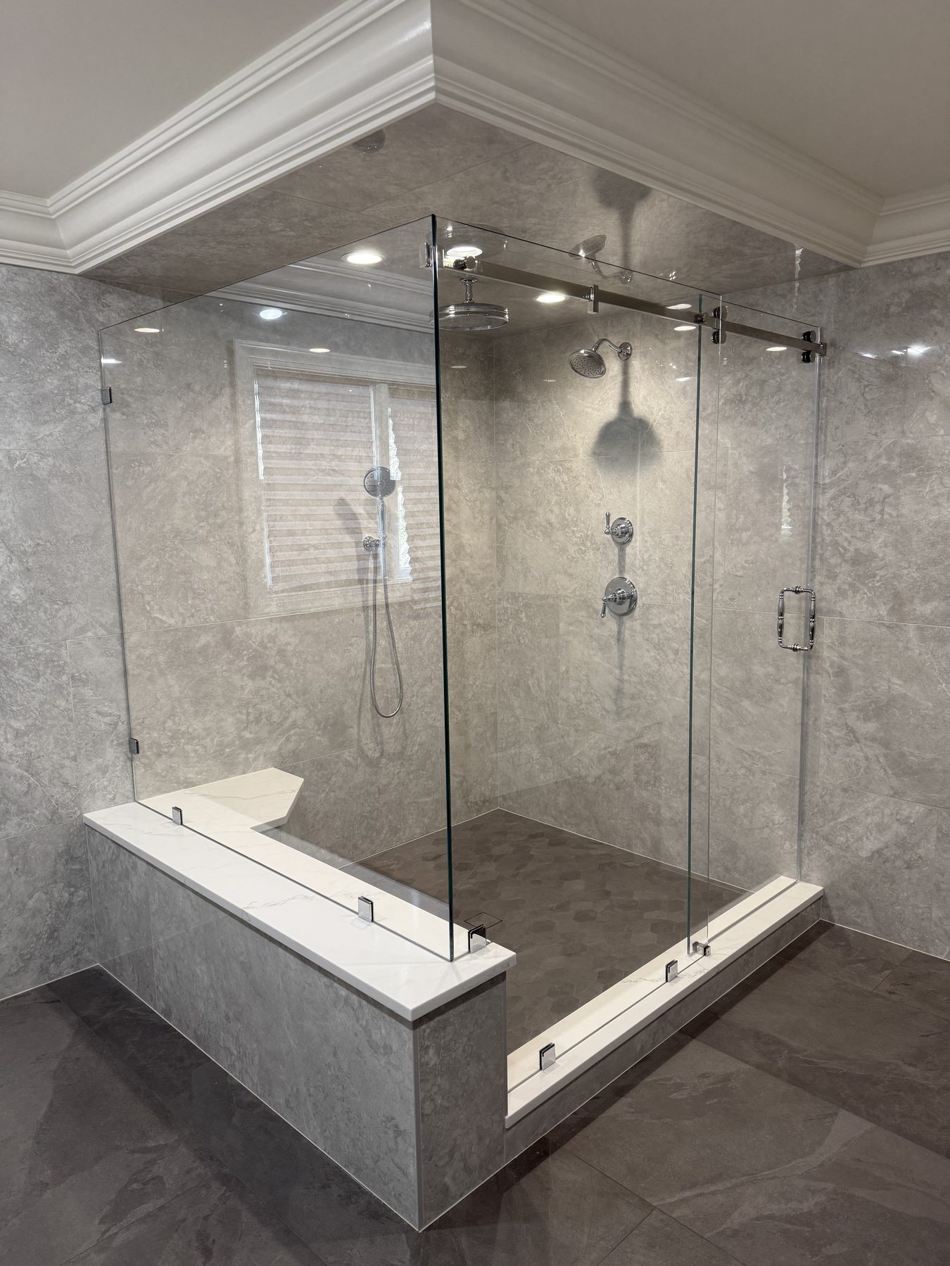 Frameless glass shower with bench seat