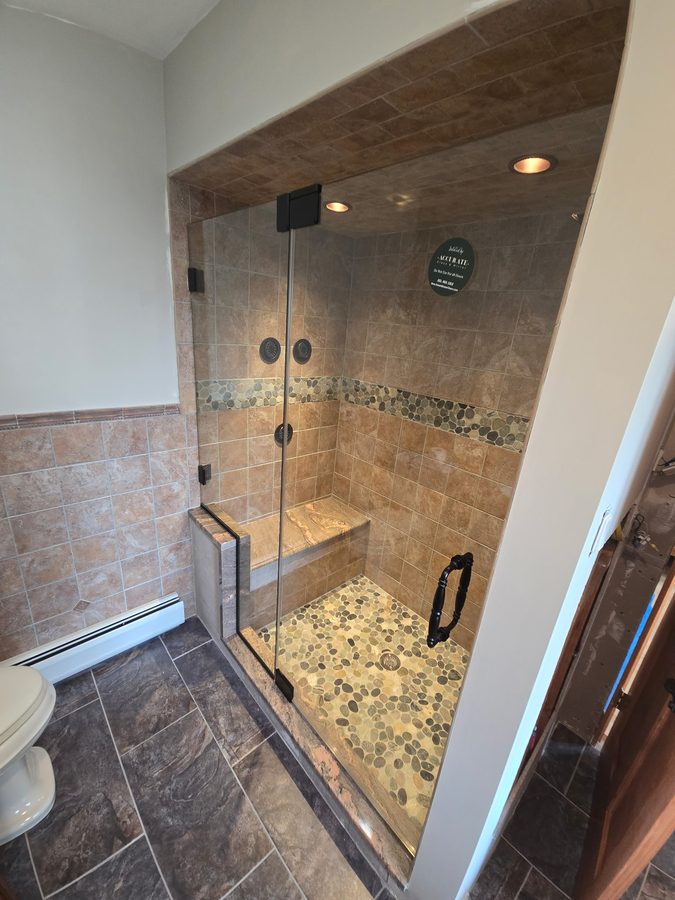 Frameless shower enclosure
