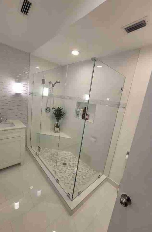 Corner glass shower enclosure