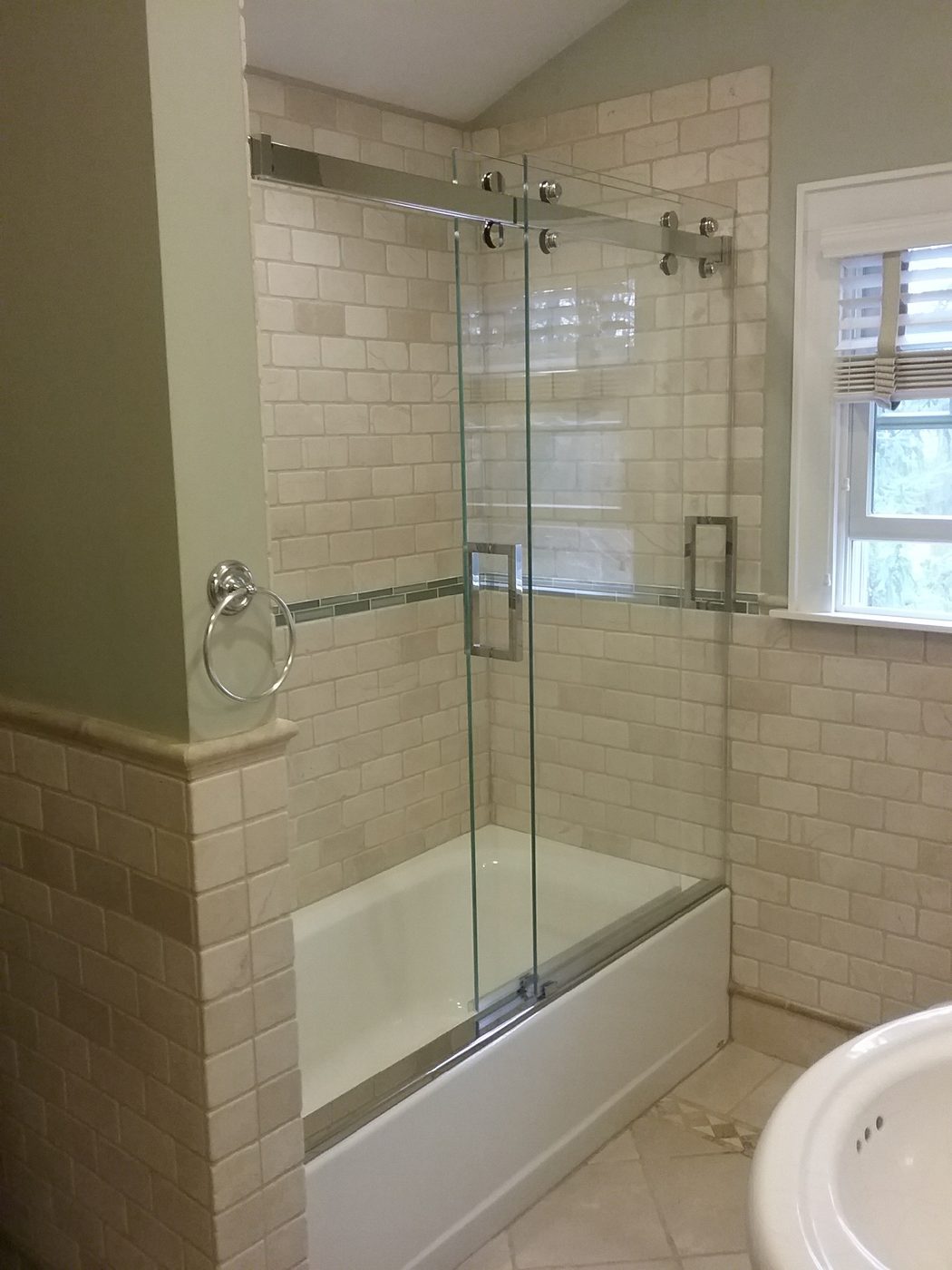 Frameless sliding tub doors on a subway tile wall