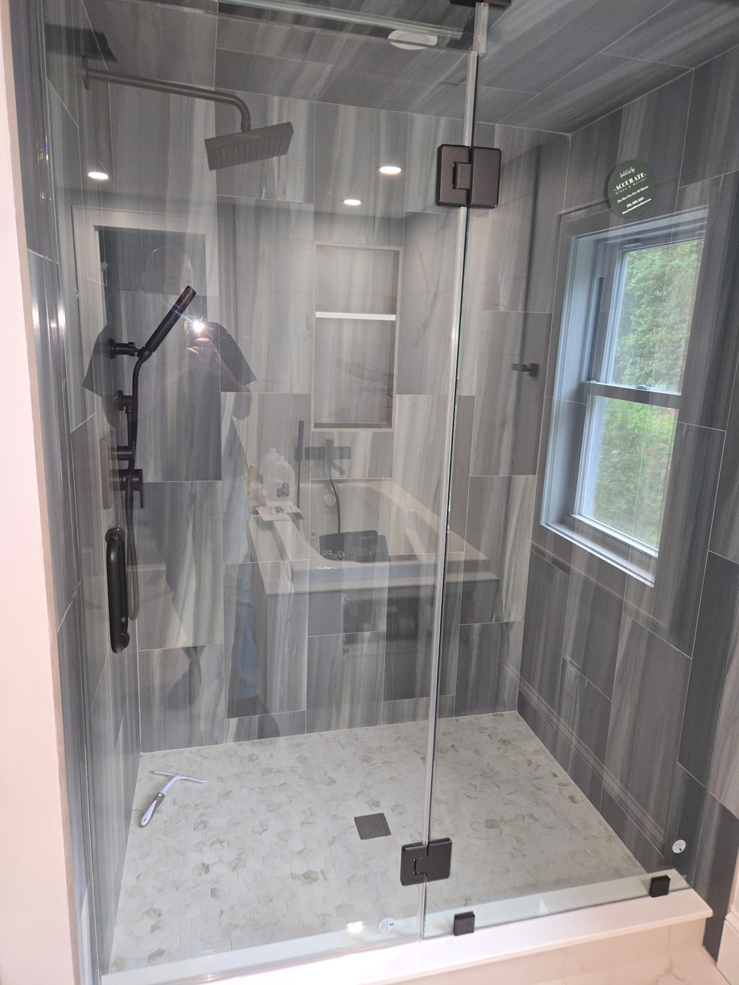 Corner frameless glass shower with patterned tile