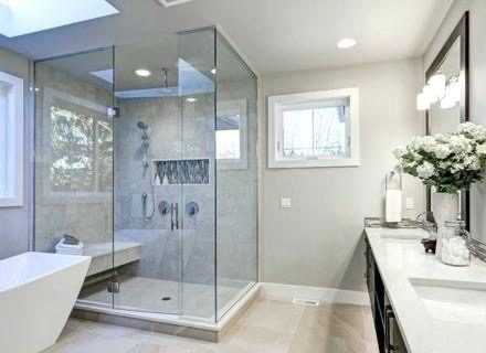 Black-framed glass shower beside a freestanding tub