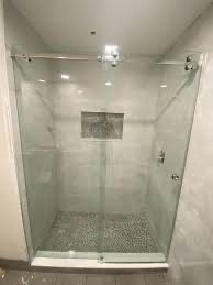 Frameless corner glass shower with white tile