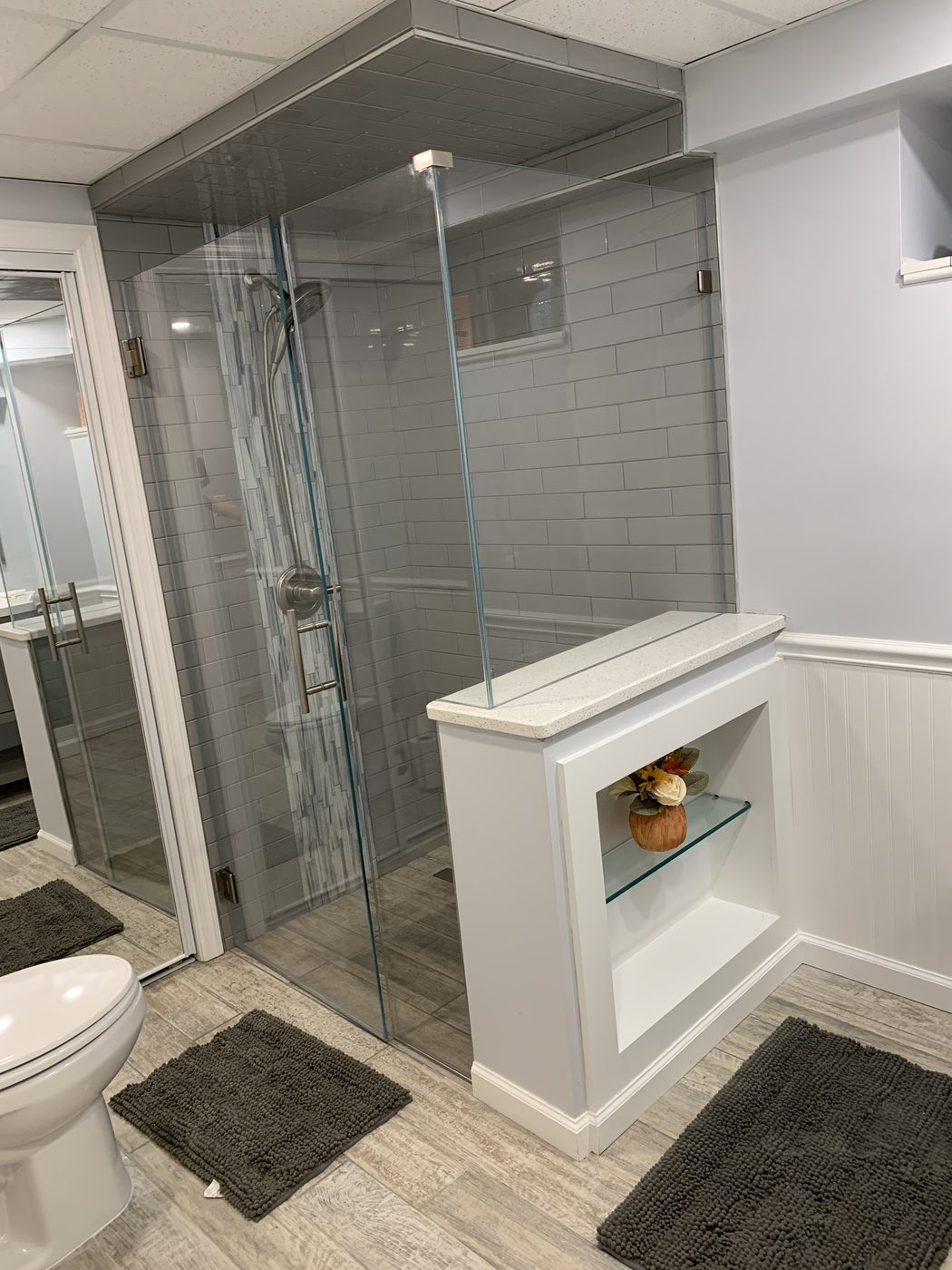 Frameless glass shower with built-in niche and dark accent tile