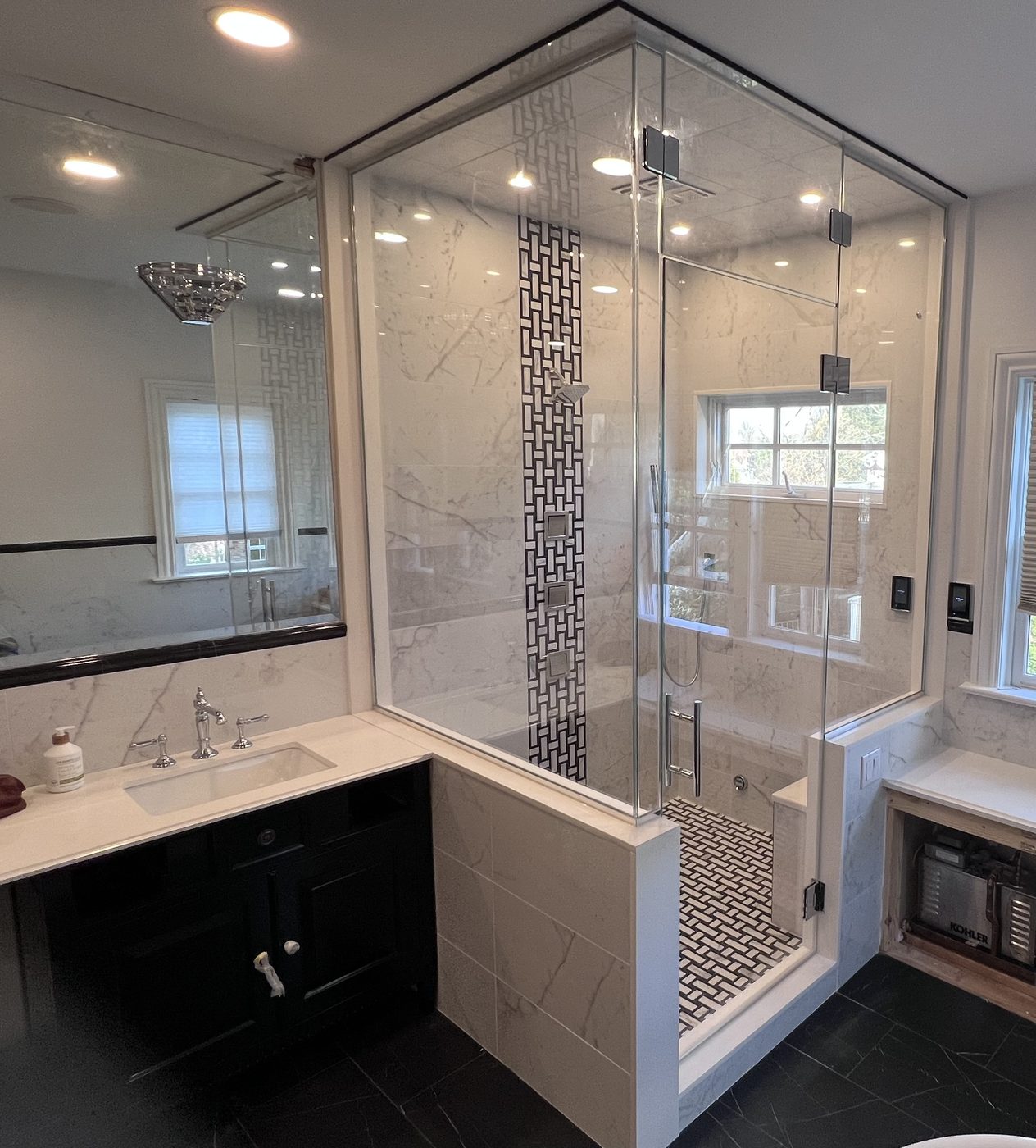 Frameless glass shower beside a double vanity