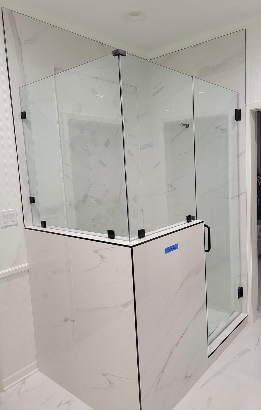 Neo-angle frameless glass shower enclosure with black hardware