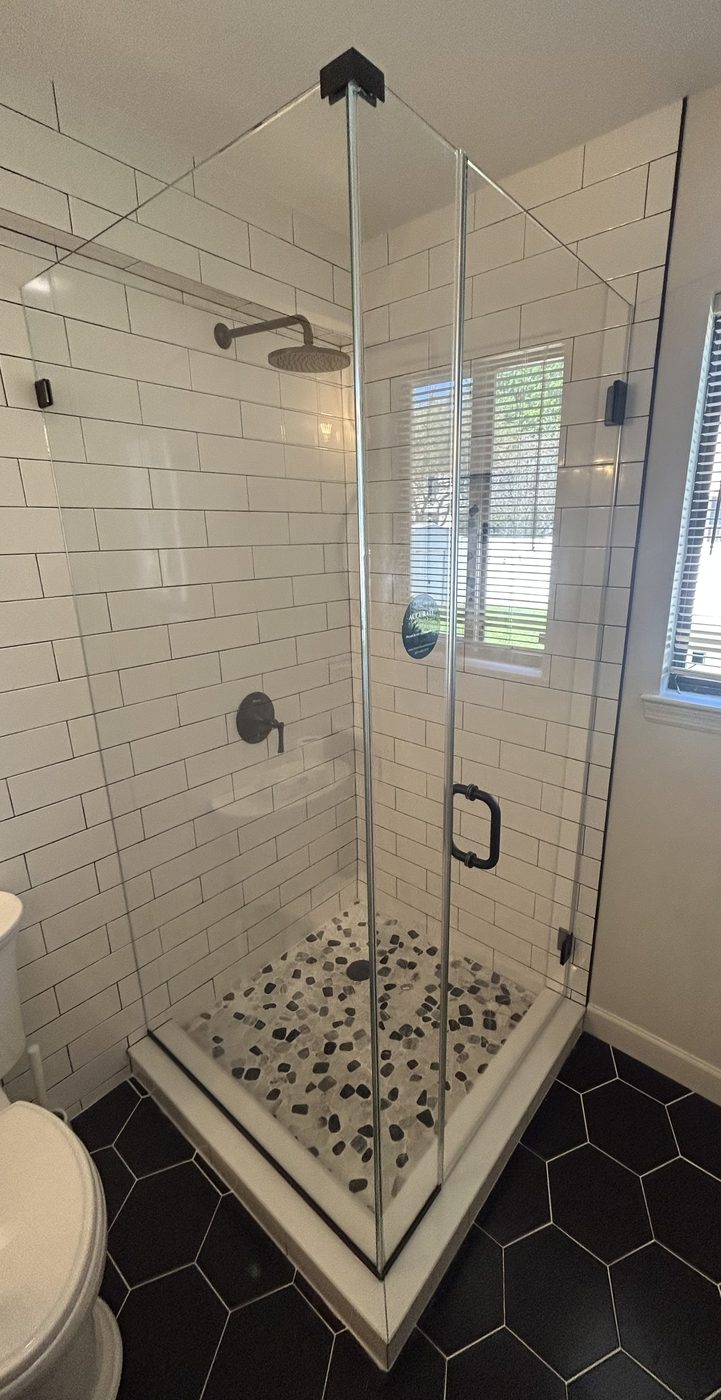 Frameless glass shower with hexagon mosaic floor