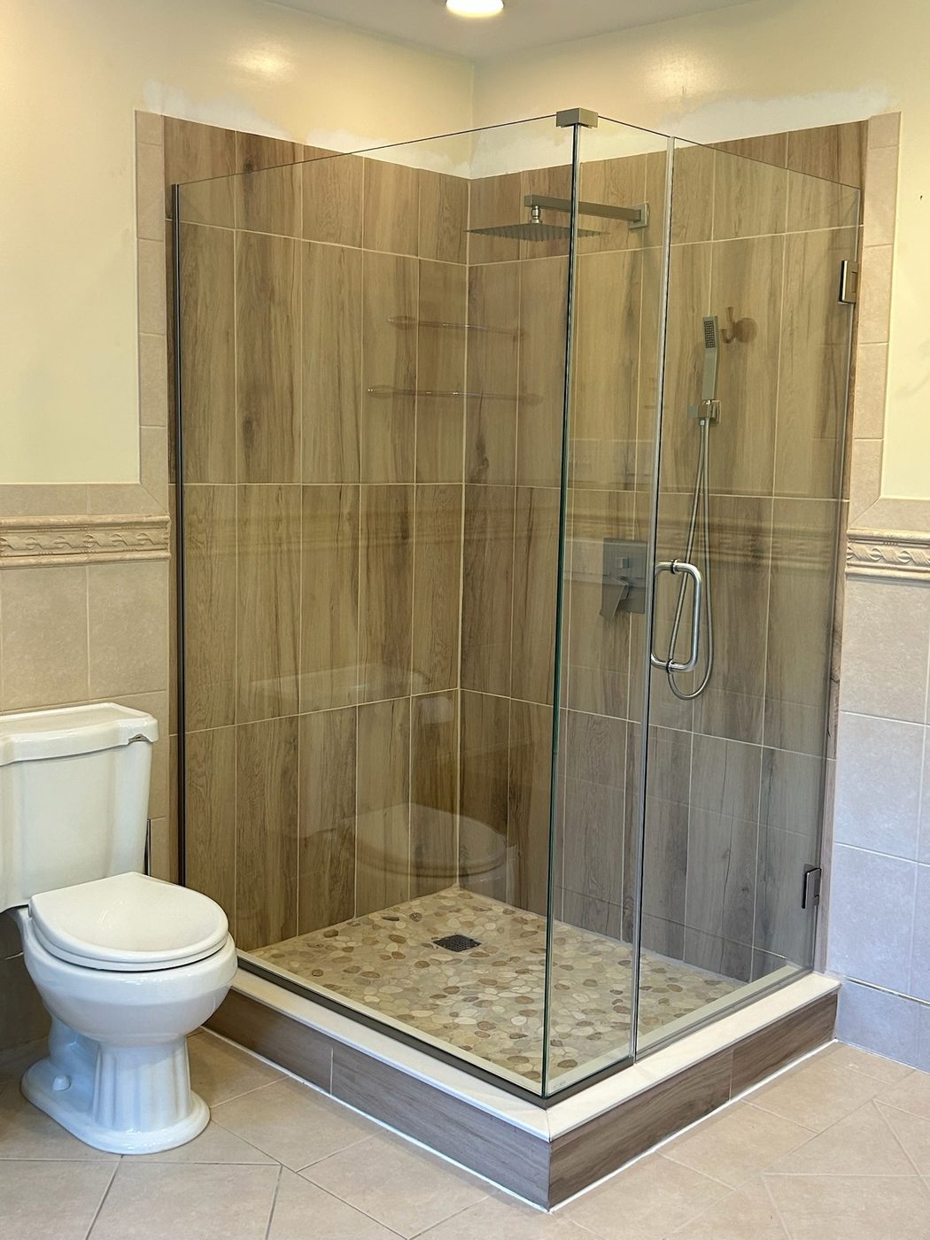 Neo-angle frameless shower with wood-look tile