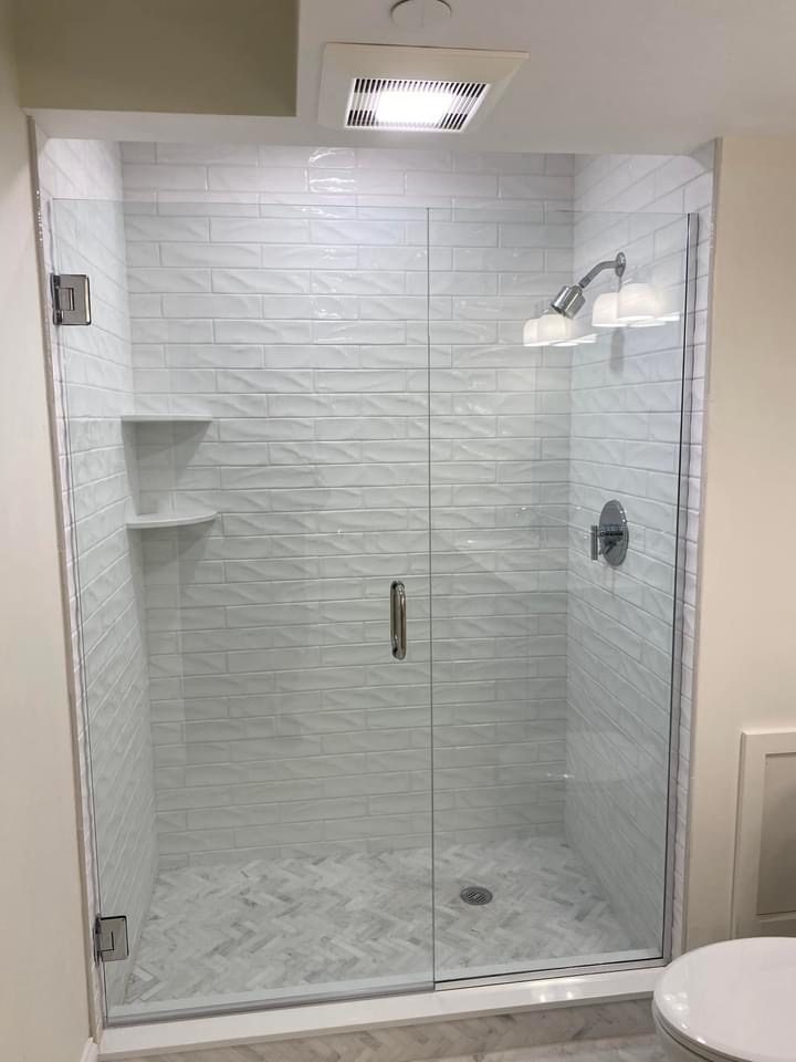 Frameless glass shower with built-in shelving niche