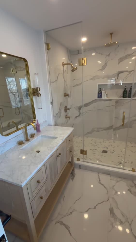 Walk-through of a marble bathroom with a frameless shower